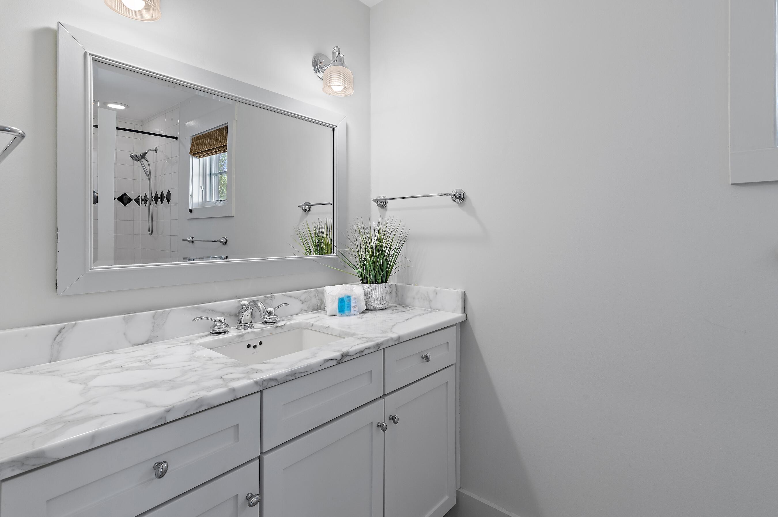 182 Kingston Road Inlet Beach, FL 32461 - Photo 30 of 55 a bathroom with a granite countertop sink and a mirror