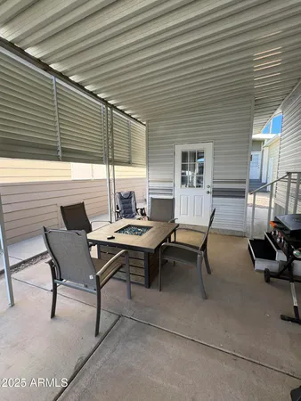 a backyard of a house with outdoor seating