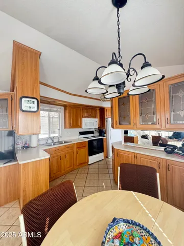 a kitchen with stainless steel appliances kitchen island granite countertop a sink and cabinets