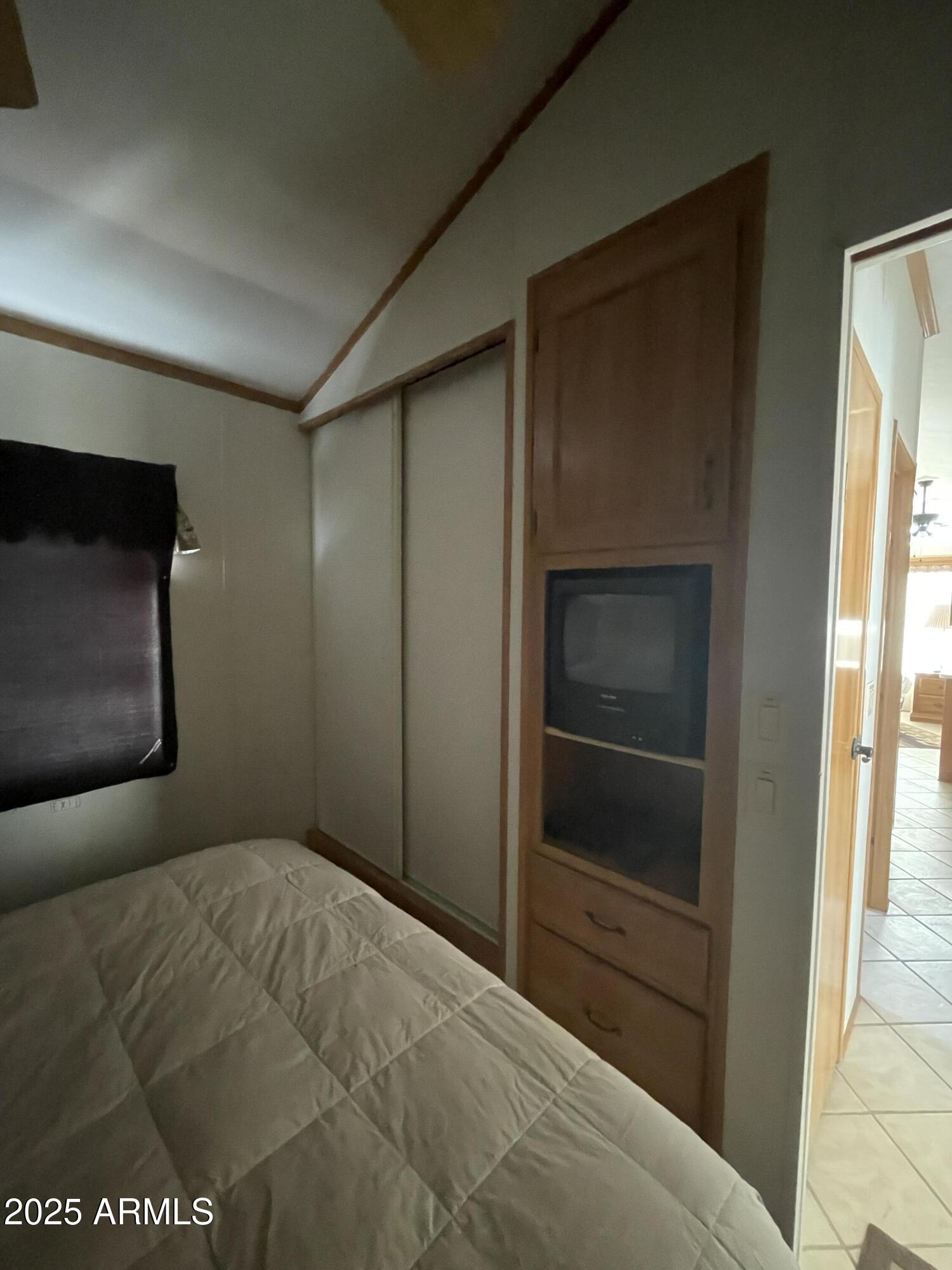 1448 South Zuni Apache Junction Apache Junction, AZ 85119 - Photo 9 of 13 a bedroom with a bed and a television