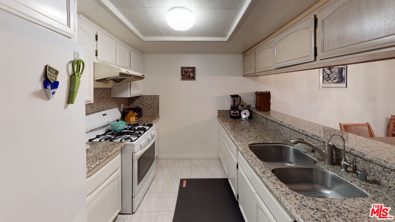 522 West Stocker Street, Unit 7 Glendale, CA 91202 - Photo 2 of 12 a kitchen with stainless steel appliances granite countertop a sink stove and refrigerator