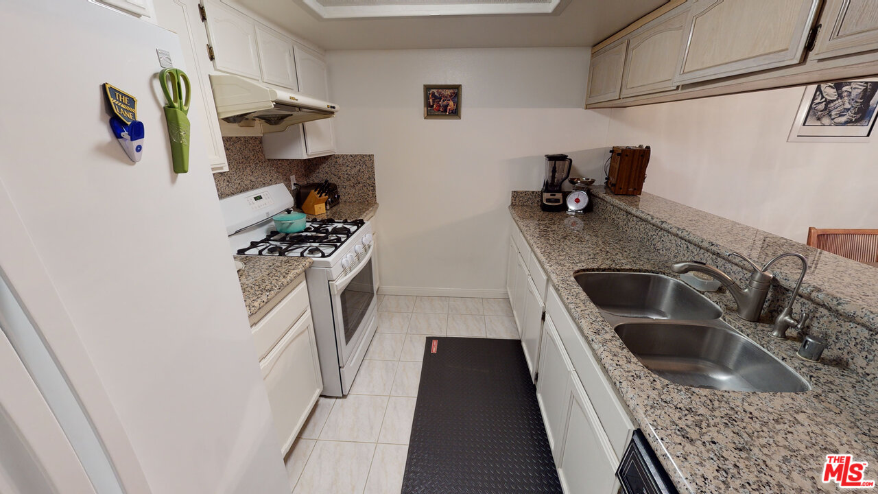 522 West Stocker Street, Unit 7 Glendale, CA 91202 - Photo 6 of 12 a kitchen with stainless steel appliances granite countertop a sink and a refrigerator