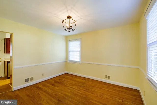 a view of a room with a window and wooden floor