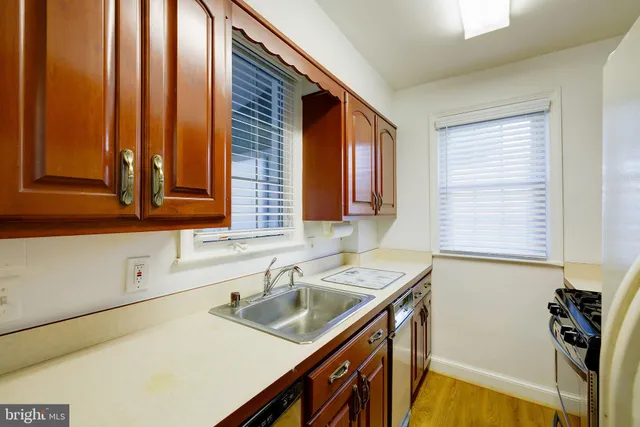 a kitchen with a sink a stove and cabinets