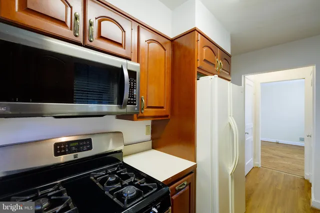 a kitchen with stainless steel appliances granite countertop a stove and a refrigerator