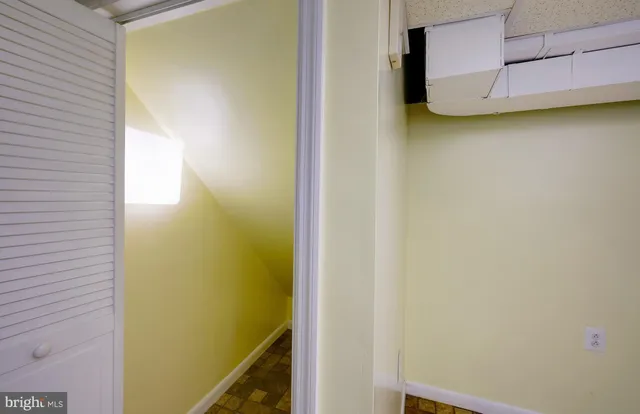 a view of hallway with furniture and a window