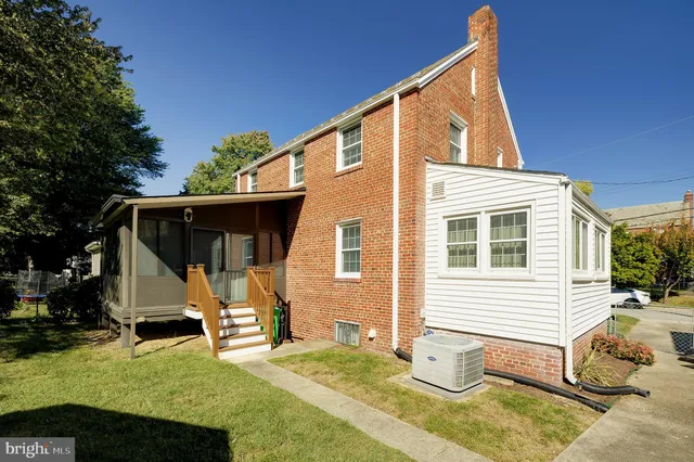 a view of a house with backyard sitting area and garden