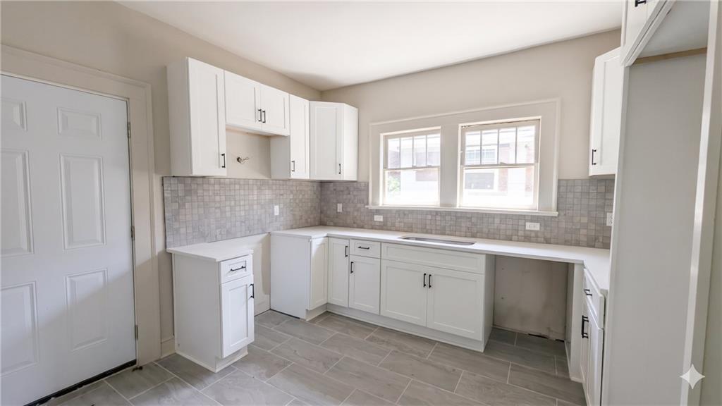 665 Lexington Avenue Southwest Atlanta, GA 30310 - Photo 6 of 33 a kitchen with granite countertop white cabinets and a sink