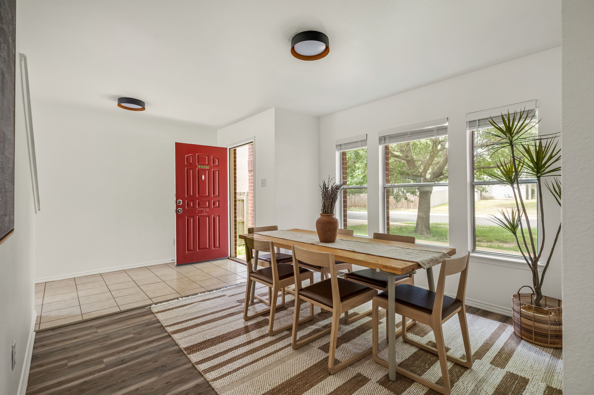 1408 Water Spaniel Way Round Rock, TX 78664 - Photo 16 of 37 A vibrant red entry door greets guests into this luminous dining space with ample natural light.