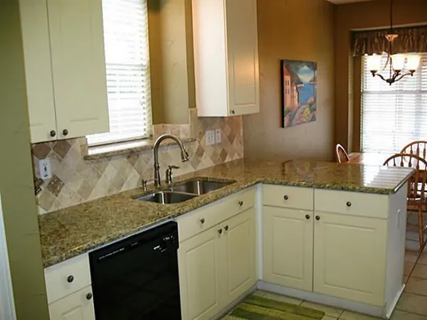 a kitchen with granite countertop a sink and a window