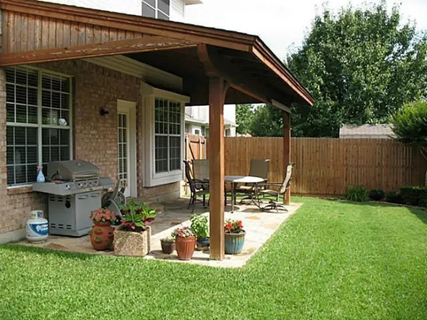 a view of a chair and table in backyard of the house
