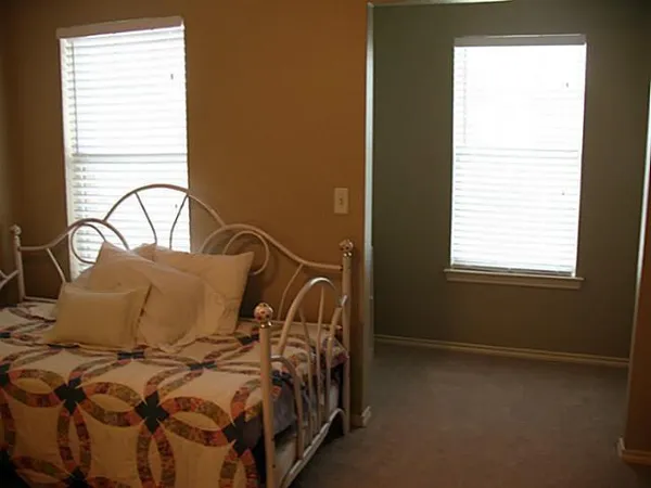 a bedroom with a bed and a window