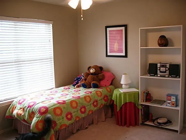 a bedroom with a bed and a window