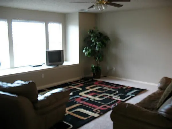 a bedroom with a bed and a potted plant