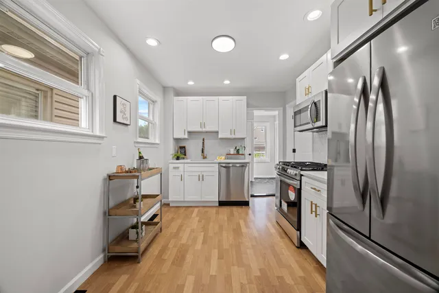 a kitchen with stainless steel appliances a refrigerator sink and cabinets