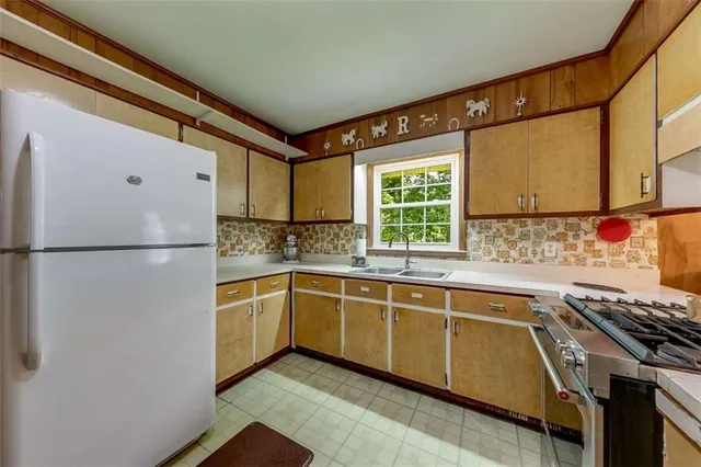 a kitchen with stainless steel appliances granite countertop a stove and a sink