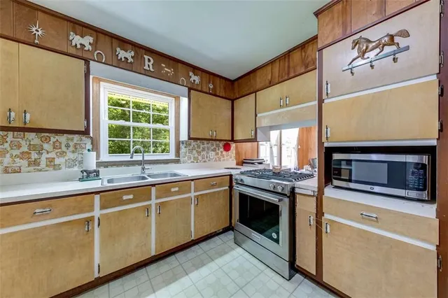 a kitchen with stainless steel appliances granite countertop a stove and a refrigerator