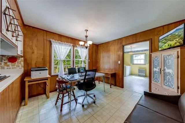 a living room with furniture a couch and a chandelier