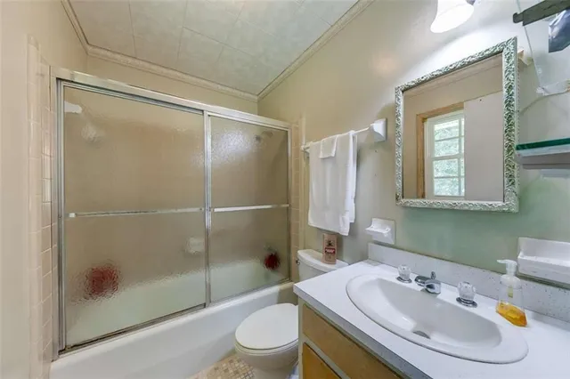 a bedroom with a bed dresser and window