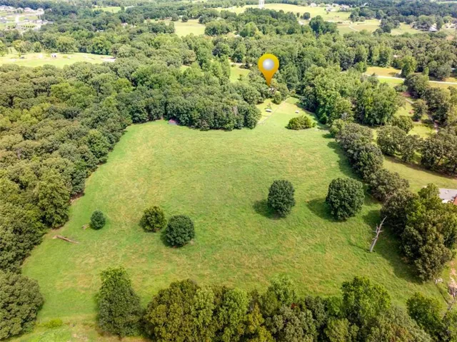 an aerial view of a houses with yard