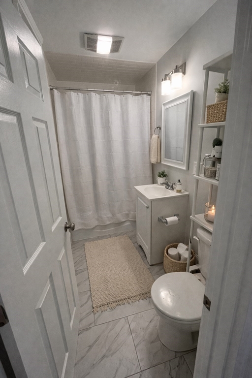 108 Bristol Road, Unit 1 Somerville, MA 02144 - Photo 20 of 24 a bathroom with a sink a toilet and shower