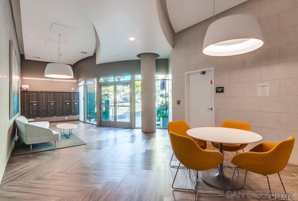 801 Ash Street, Unit 205 San Diego, CA 92101 - Photo 3 of 25 a living room with furniture and a large window