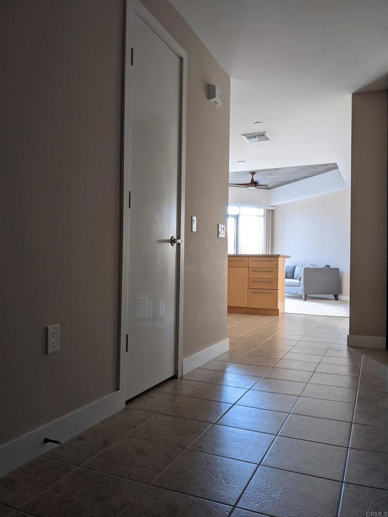 801 Ash Street, Unit 205 San Diego, CA 92101 - Photo 5 of 25 a view of kitchen with refrigerator and white cabinets
