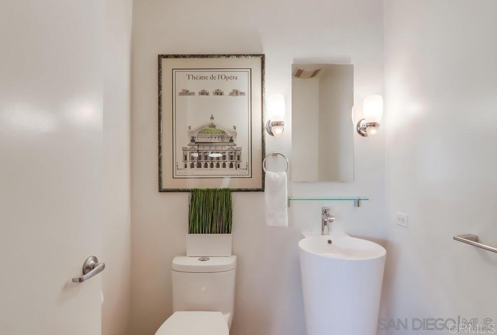 801 Ash Street, Unit 205 San Diego, CA 92101 - Photo 10 of 25 a bathroom with a toilet sink and mirror