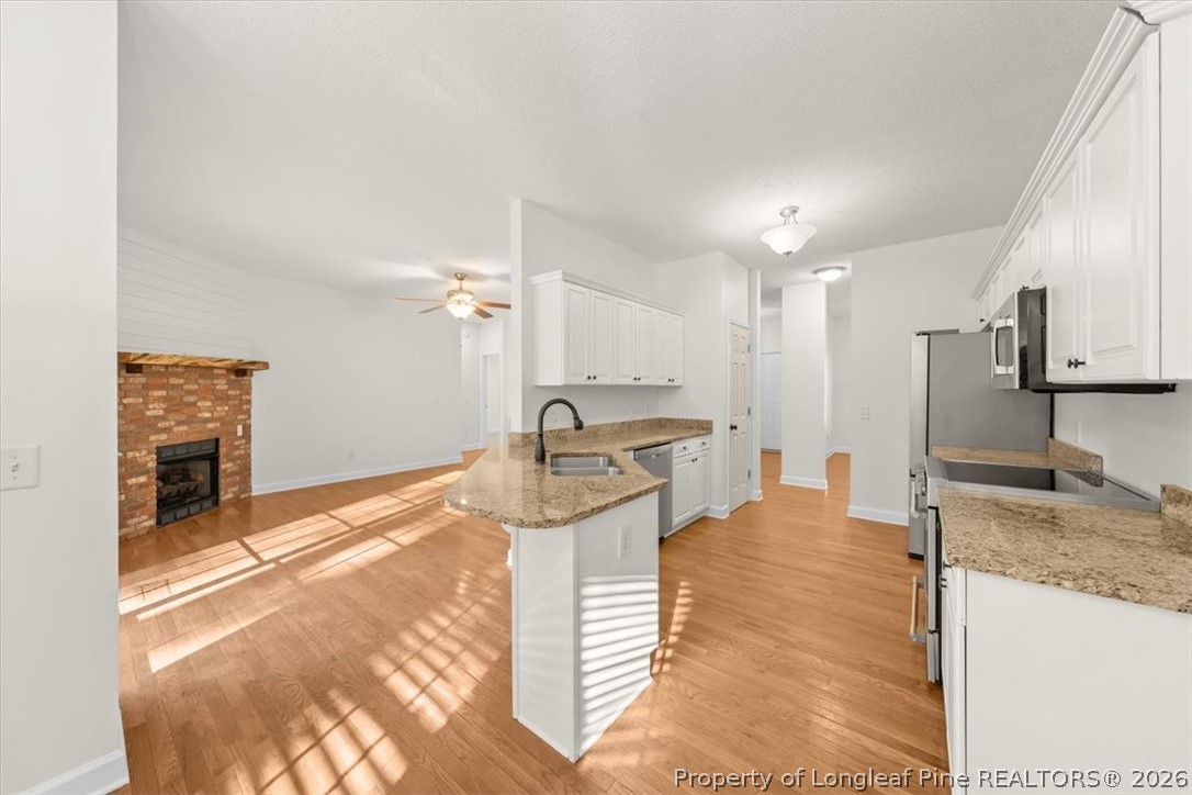60 Spring Lake Drive Pinehurst, NC 28374 - Photo 6 of 42 a view of a kitchen with kitchen island a sink stainless steel appliances and cabinets
