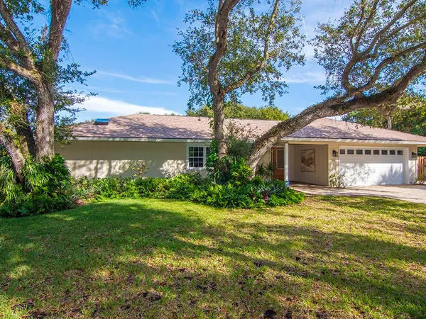 a kitchen with stainless steel appliances granite countertop wooden cabinets a sink dishwasher a stove and a refrigerator with wooden floor