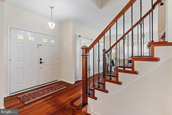 a view of entryway with wooden floor and stairs