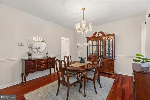 a view of a dining room with furniture wooden floor and chandelier
