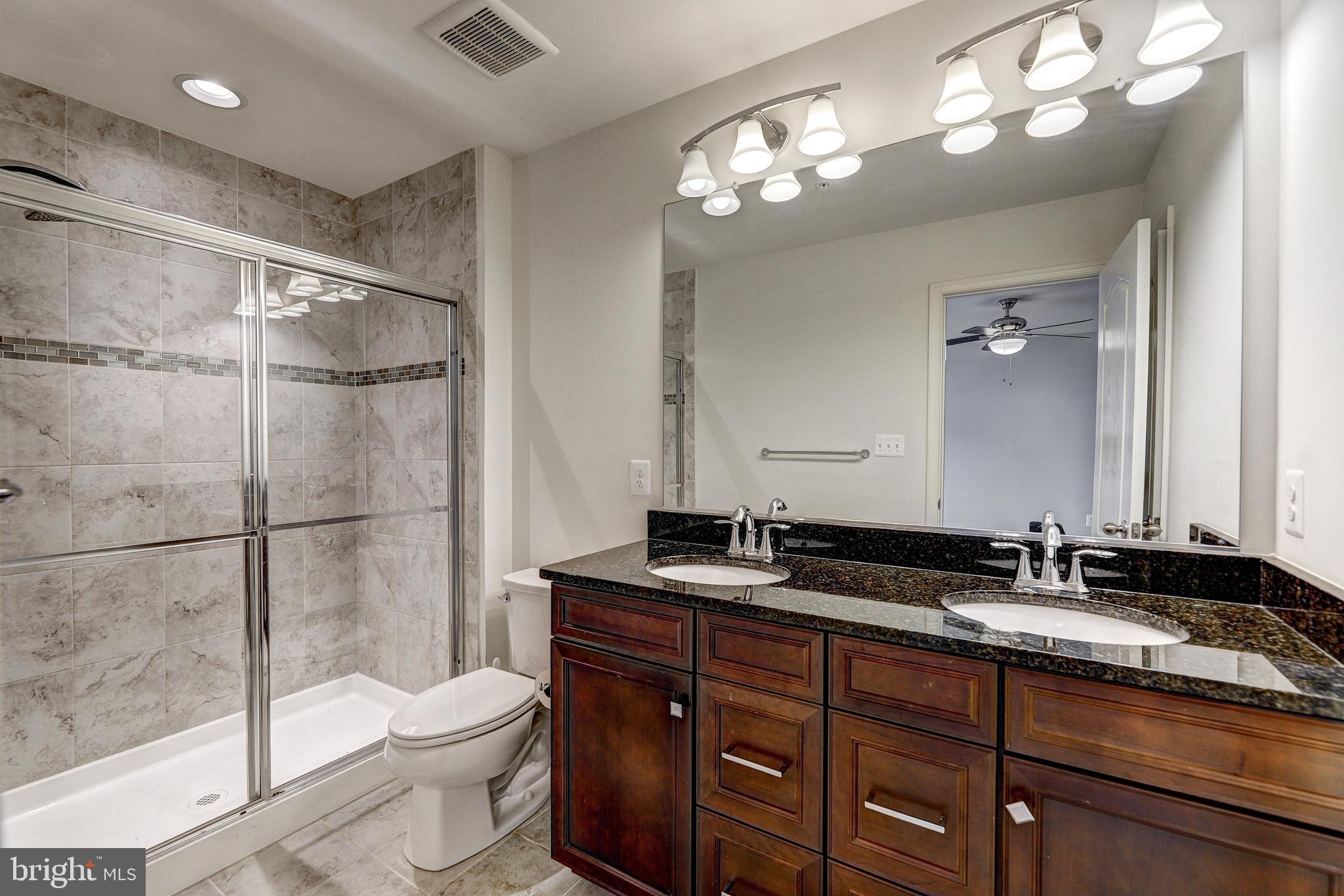 912 Winter Run Road Middle River, MD 21220 - Photo 27 of 55 a bathroom with a sink vanity granite toilet and a mirror