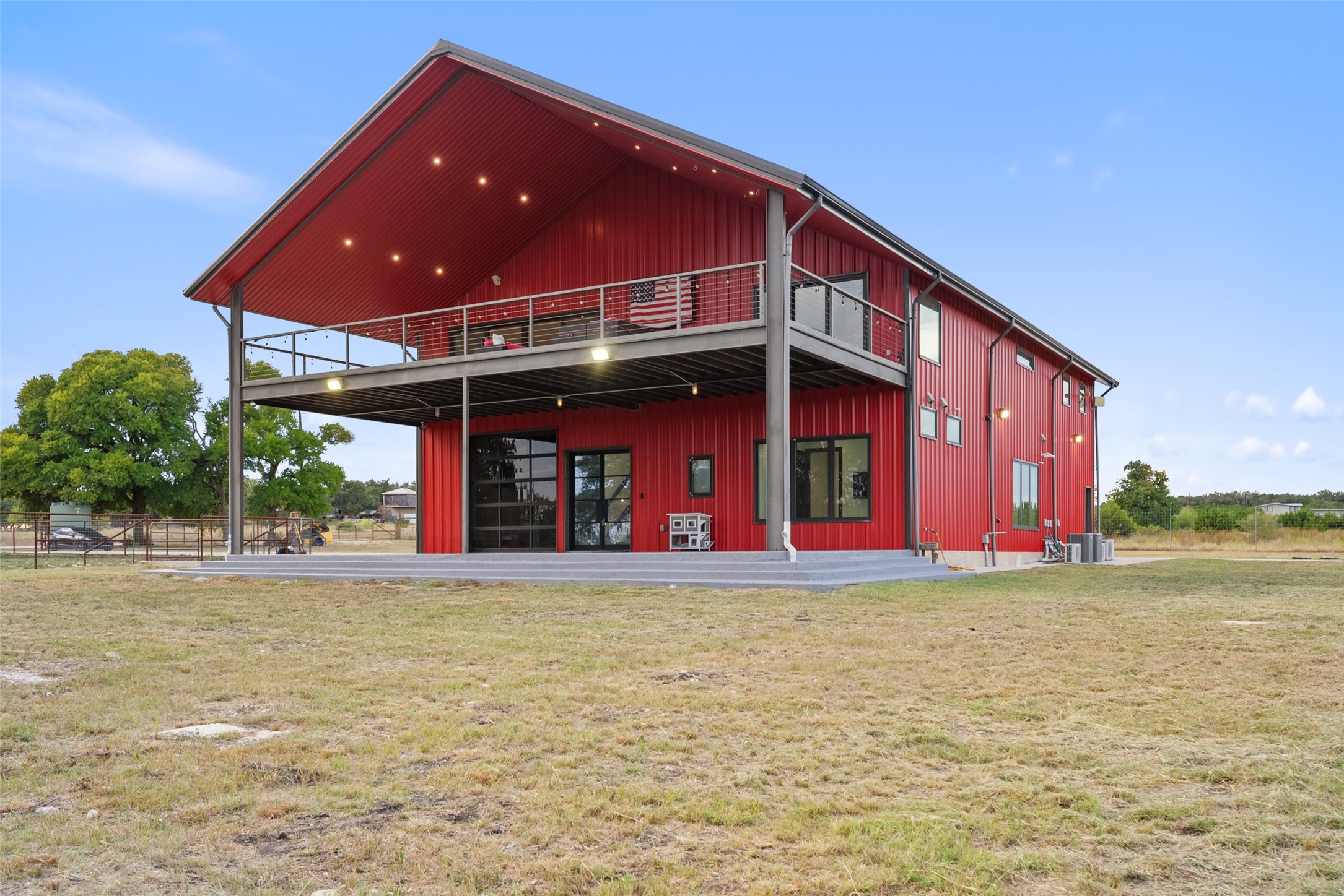 561 Broken Bit Trail Dripping Springs, TX 78620 - Photo 36 of 40 Back of property with a patio, a yard, and board and batten siding
