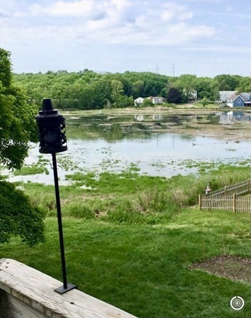 67 Colonial Road Weymouth, MA 02191 - Photo 16 of 31 a view of a lake with a big yard