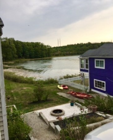 67 Colonial Road Weymouth, MA 02191 - Photo 29 of 31 a view of a lake with a house in the background