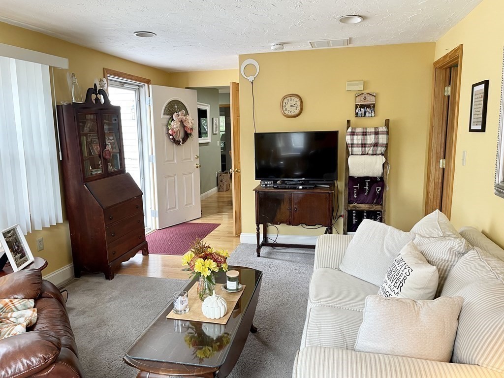 67 Colonial Road Weymouth, MA 02191 - Photo 6 of 31 a living room with furniture and a flat screen tv