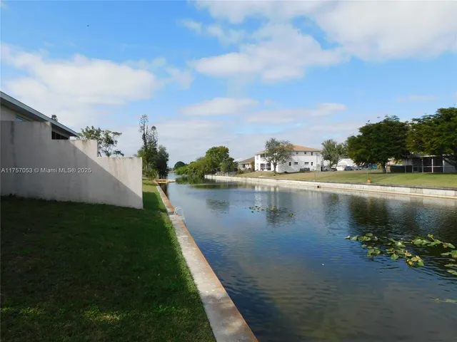 a view of a lake with houses in the back