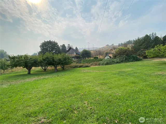 a backyard of a house with lots of green space and fog