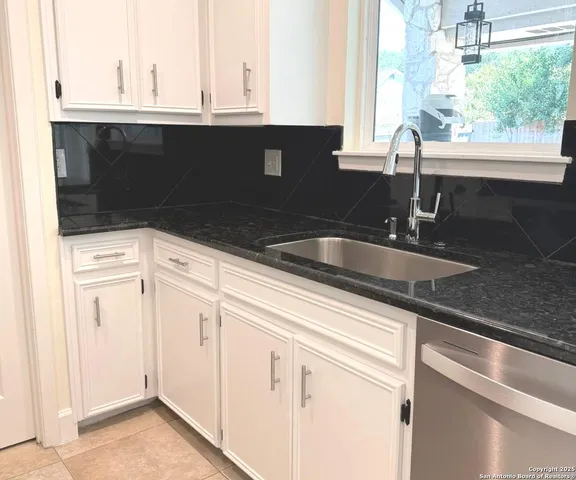 a kitchen with a sink and cabinets