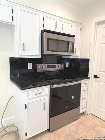 a kitchen with a sink and a microwave