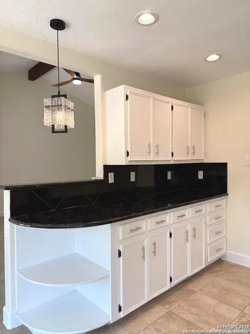 a kitchen with a sink and cabinets