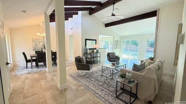 a living room with furniture a dining table and chairs with rug