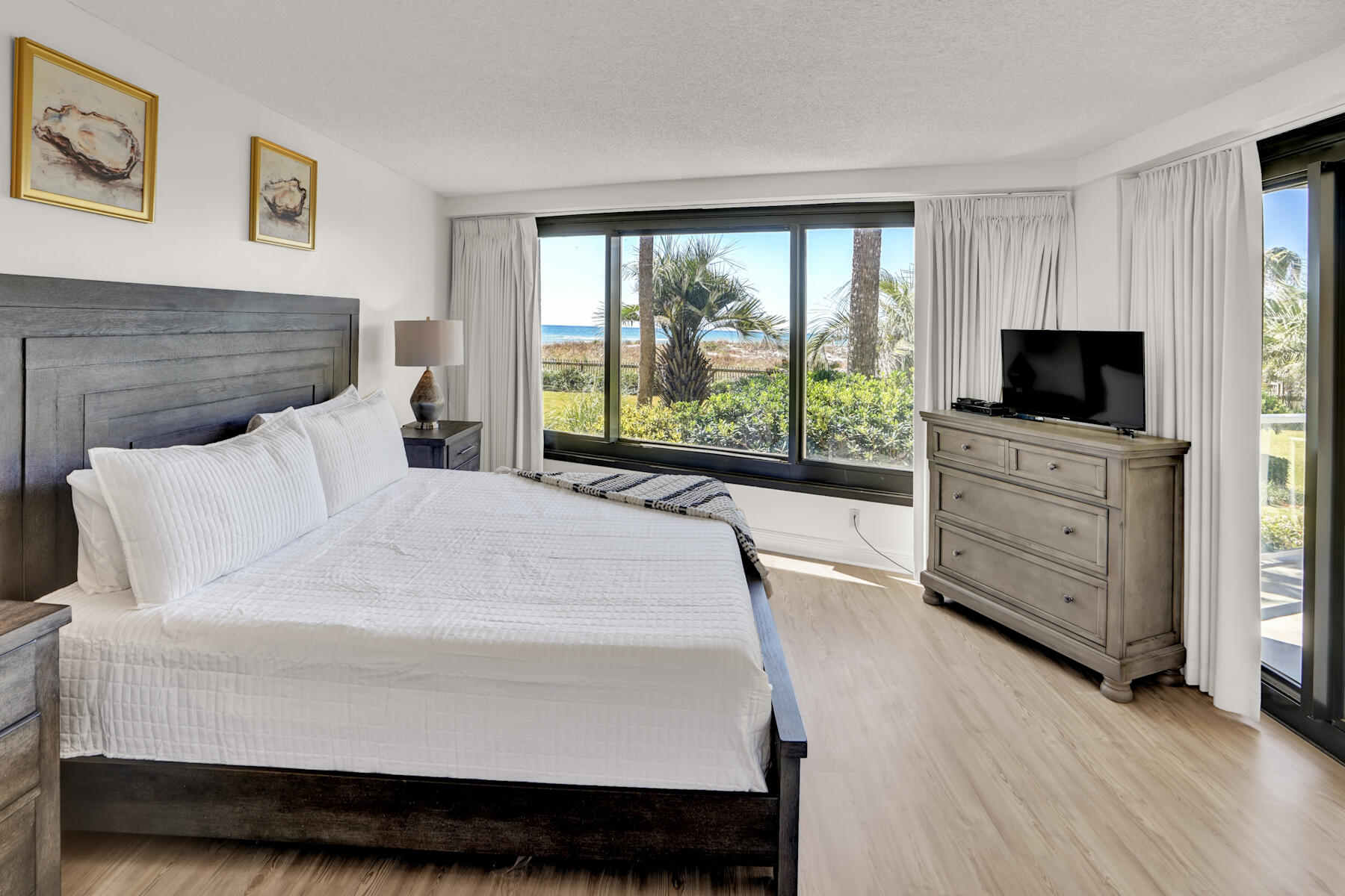 4202 Beachside 2, Unit 202 Miramar Beach, FL 32550 - Photo 11 of 45 a bedroom with a bed and a flat tv screen on dresser