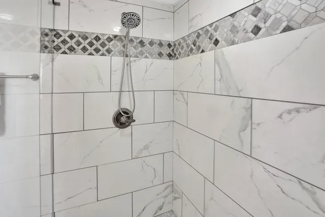 a bathroom with a shower and a shower