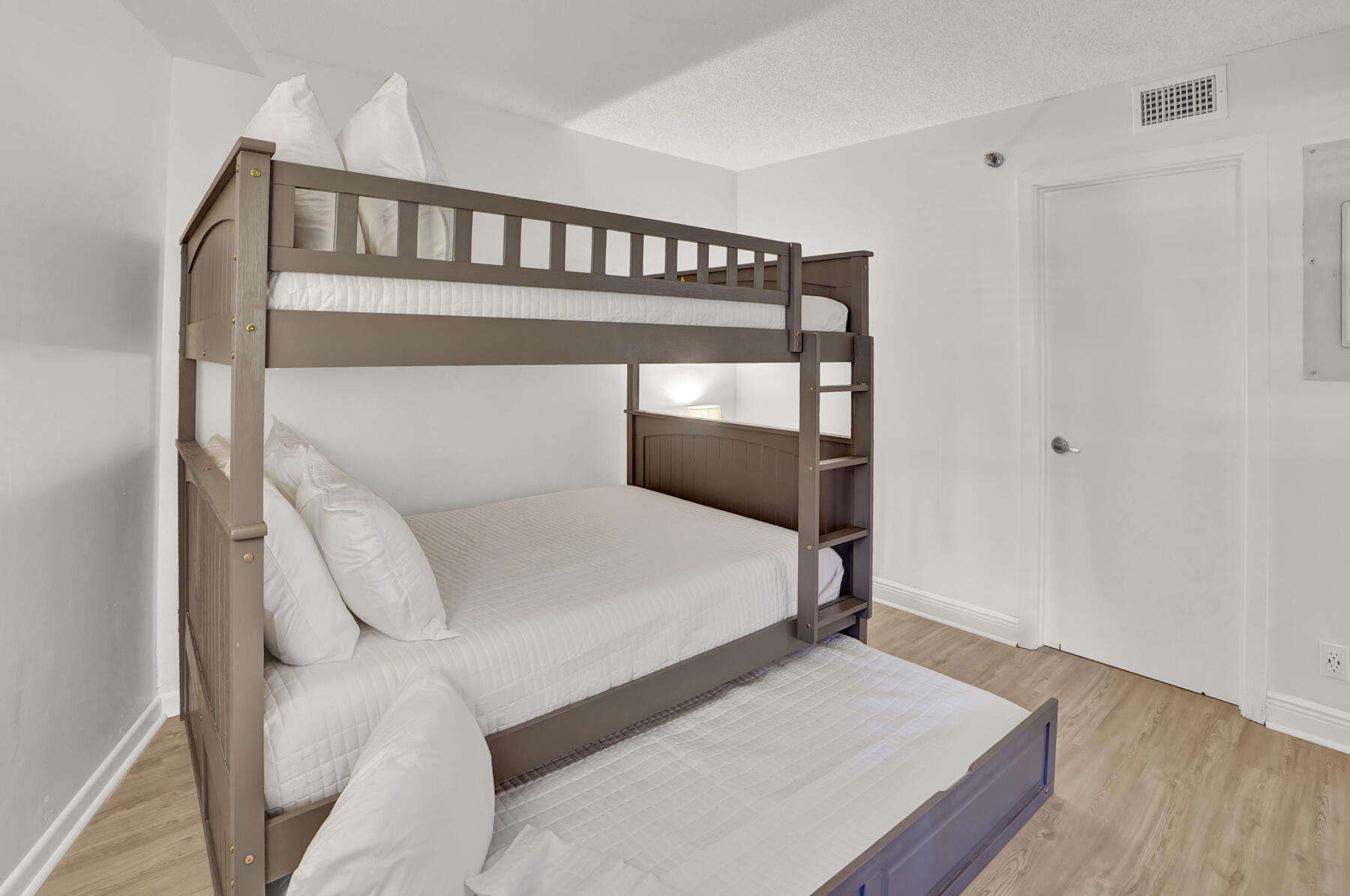 4202 Beachside 2, Unit 202 Miramar Beach, FL 32550 - Photo 18 of 45 a bedroom with a bed and wooden floor