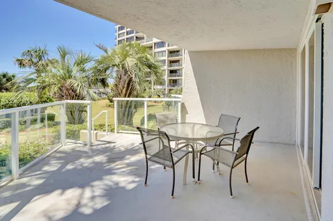 a view of a dining room with furniture and a potted plant