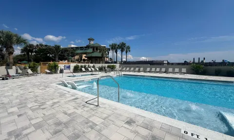 a swimming pool with outdoor seating and yard