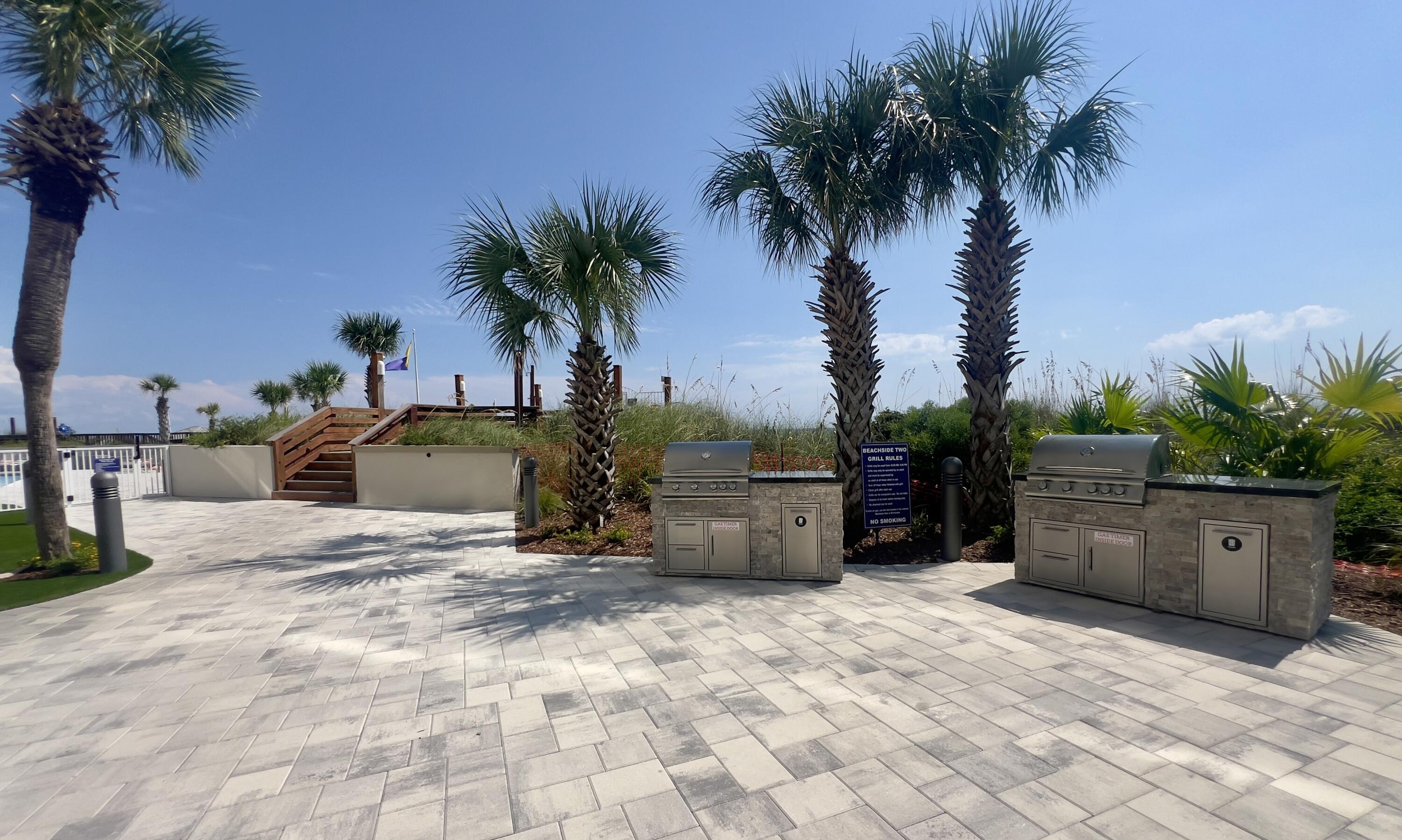 4202 Beachside 2, Unit 202 Miramar Beach, FL 32550 - Photo 30 of 45 a view of a backyard space with potted plants and palm trees
