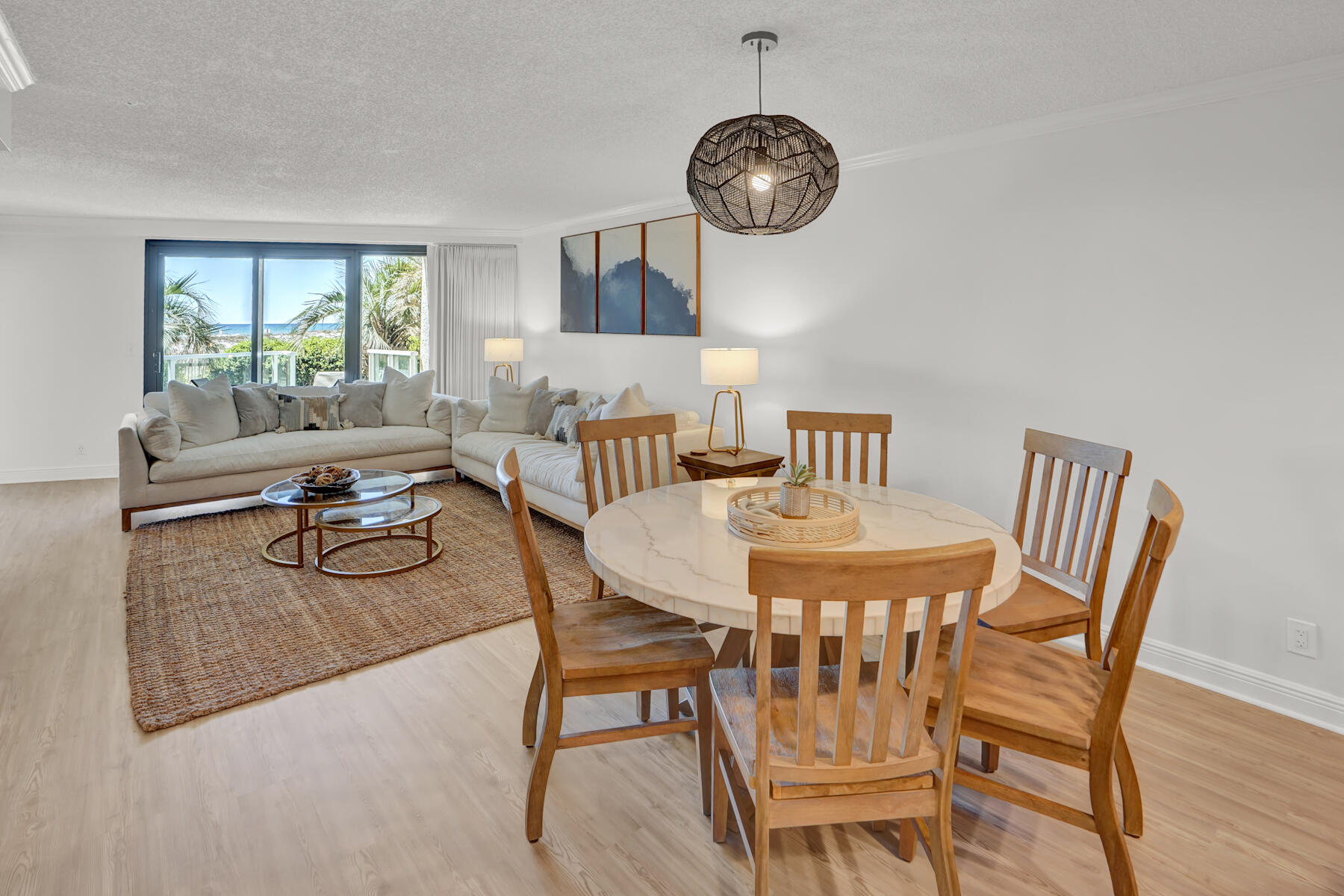 4202 Beachside 2, Unit 202 Miramar Beach, FL 32550 - Photo 5 of 45 a dining room with furniture a chandelier and wooden floor